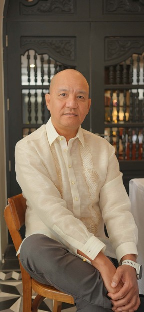 Emelino T. Maestro, CPA, seated, wearing a barong